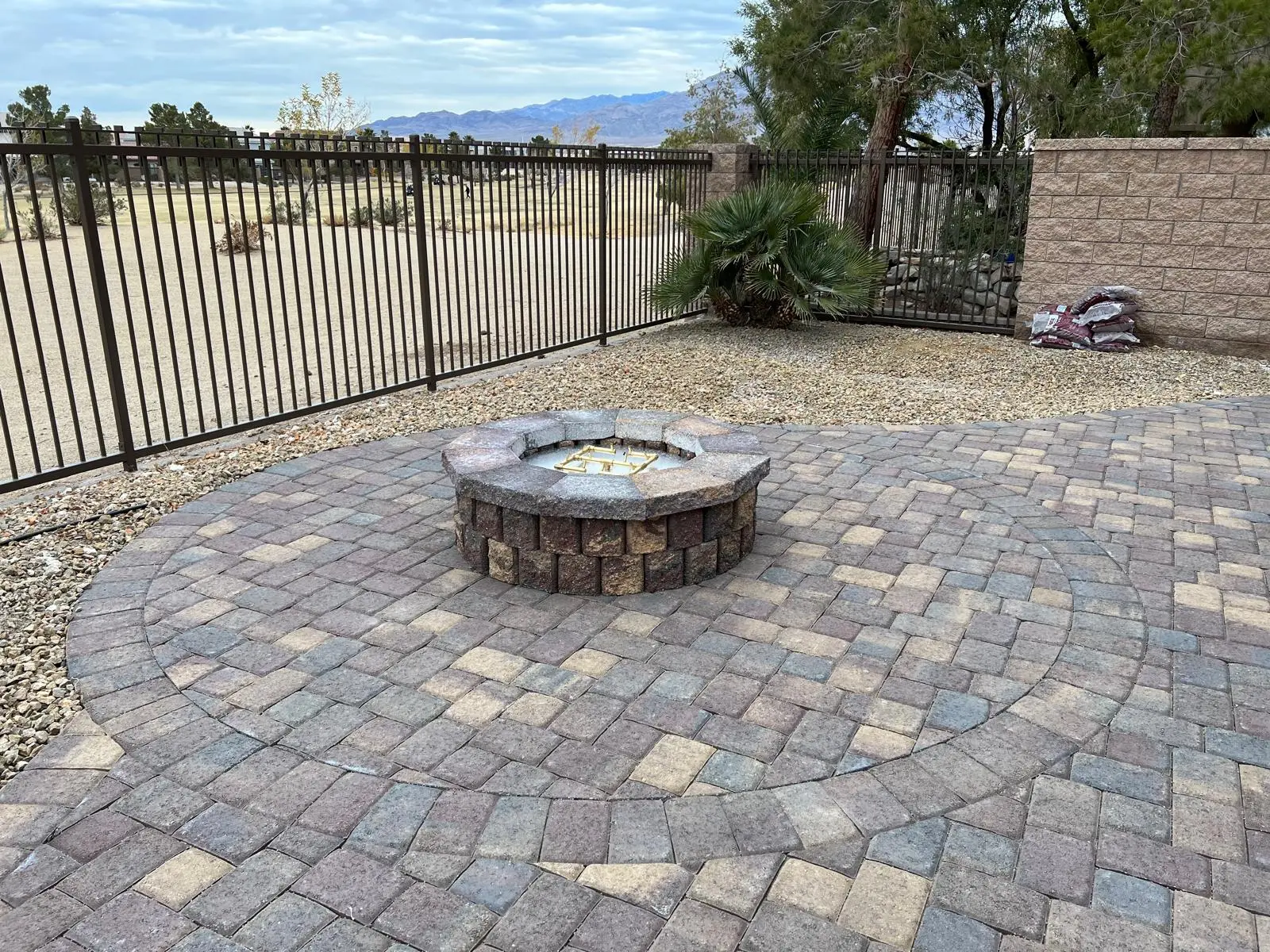 Paver fire pit & fireplace in Las Vegas with a custom paver surround and seating