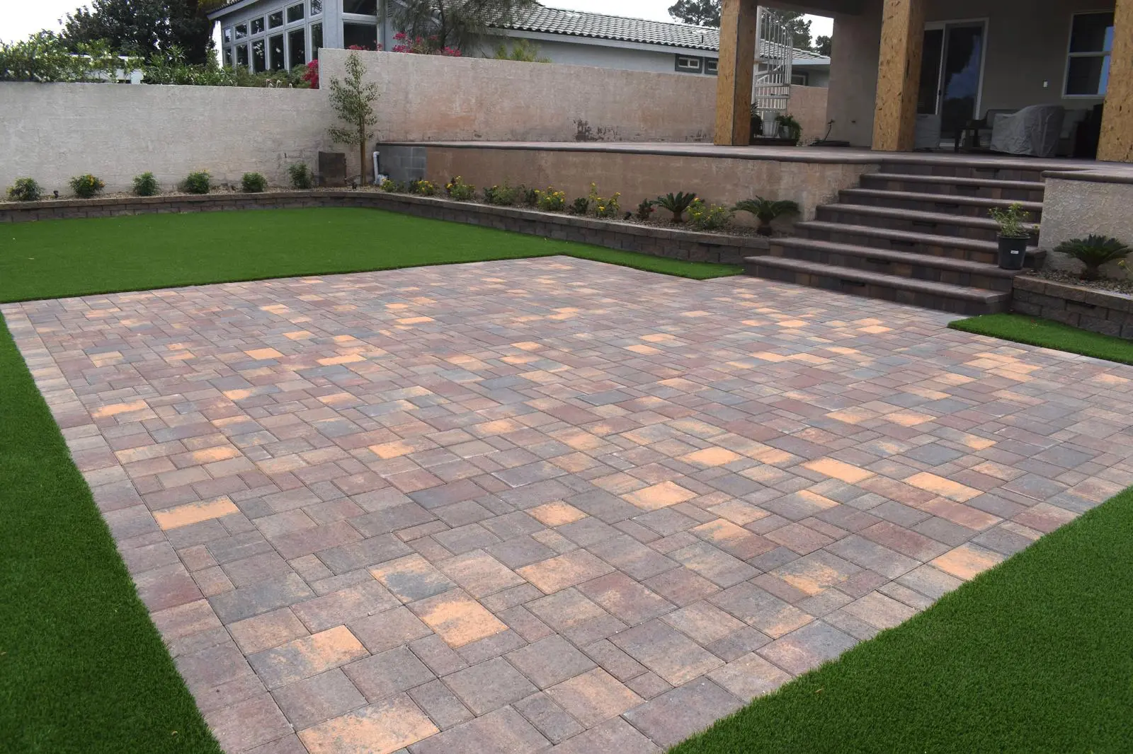 Paver patio in Las Vegas with a custom fire feature and seating