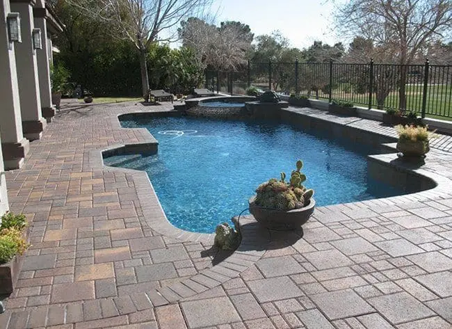 Paver pool deck in Las Vegas surrounding a resort-style backyard pool