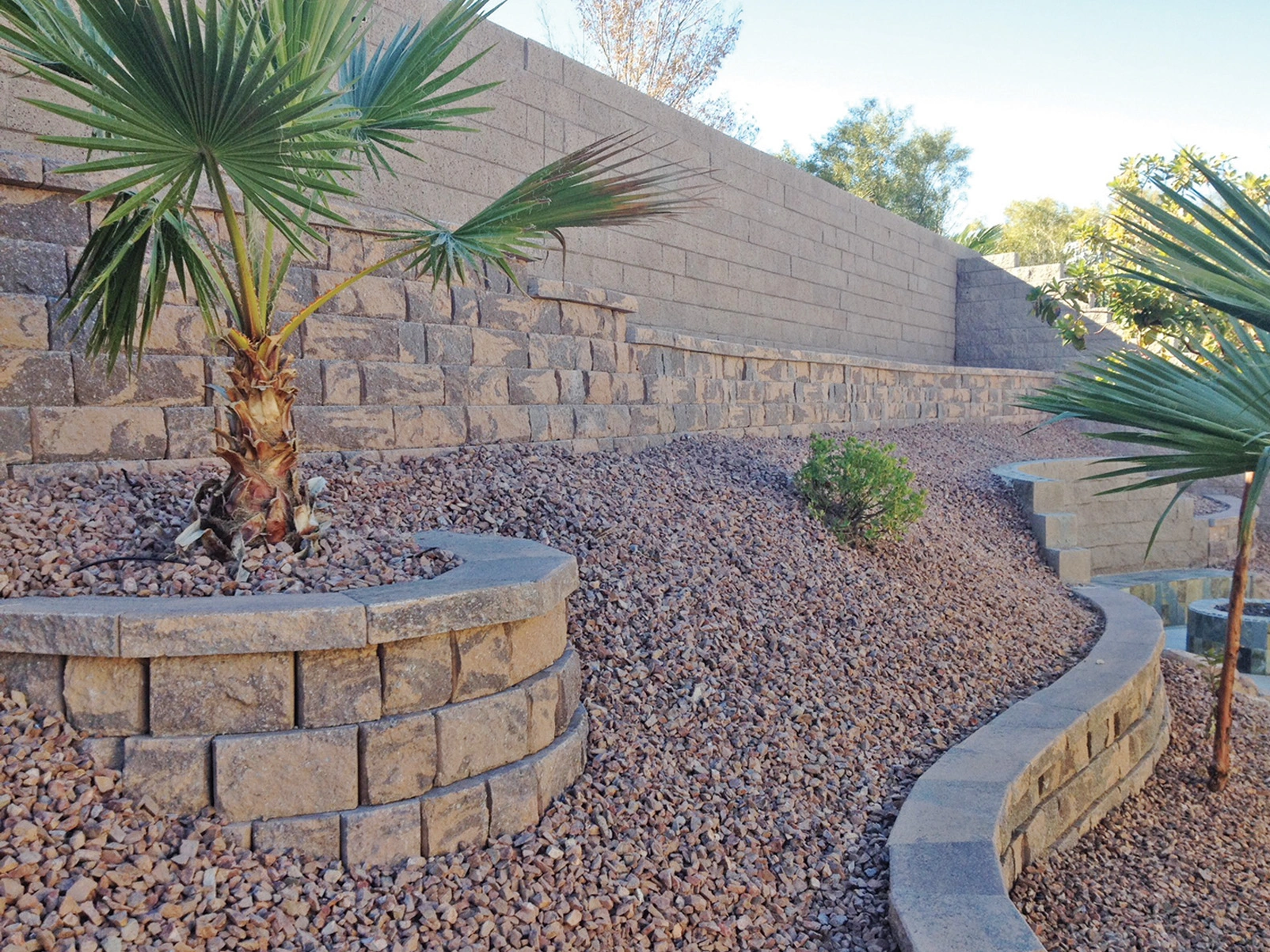 Paver retaining wall in Las Vegas terracing a sloped desert yard
